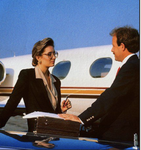 Traveller at an airport lounge window overlooking an Air Canada jet