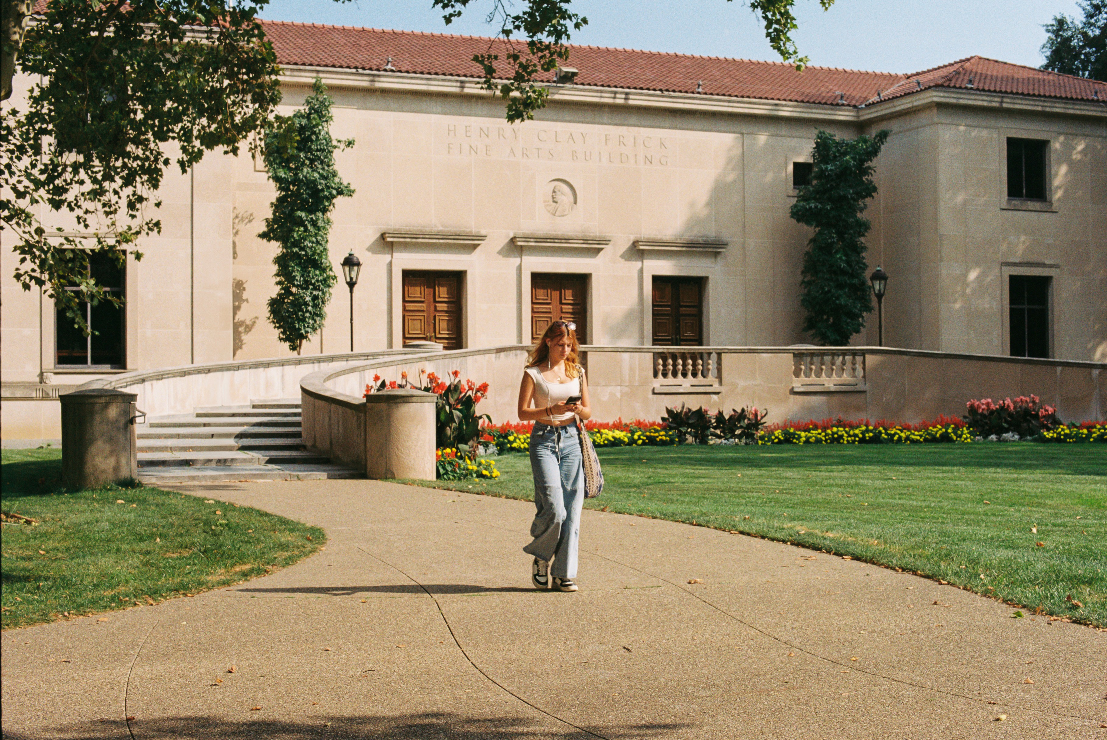Student walking outside a university fine arts building
